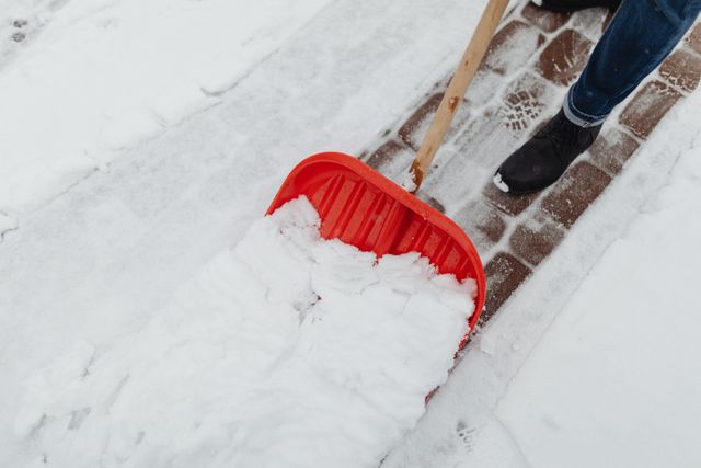 A property owner shoveling snow off a pathway in New Jersey
